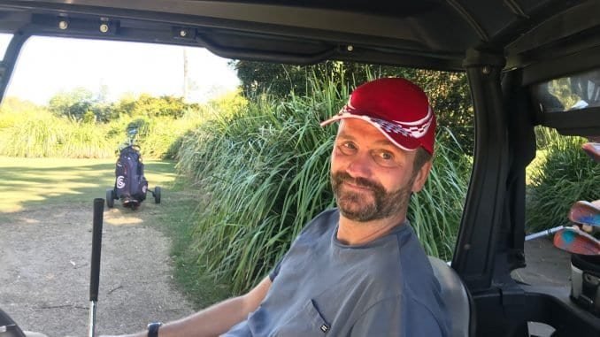 Man sitting in a golf buggy