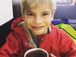 A little boy dressed in red