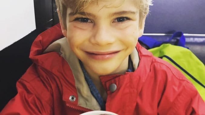 A little boy dressed in red