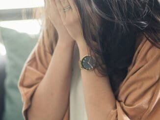 Overwhelmed woman crying, seeking support for alcohol addiction recovery at Deep Sober UK.