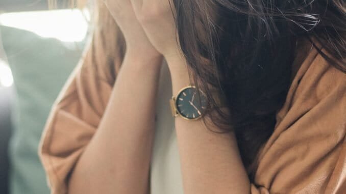 Overwhelmed woman crying, seeking support for alcohol addiction recovery at Deep Sober UK.