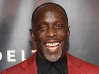 Relaxed man smiling at an event for addiction recovery and sobriety support.