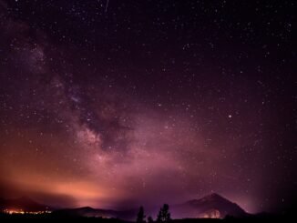 Stargazing under the Milky Way galaxy, promoting sober living and mental clarity.